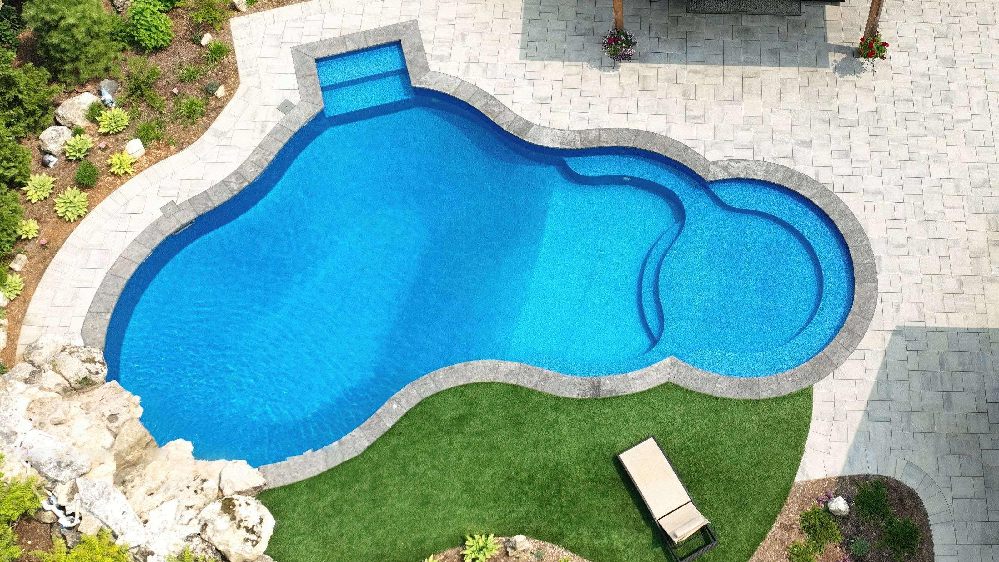 Modern swimming pool design with waterfall feature